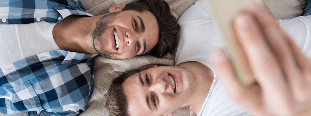 Image of 2 men taking a selfie. Photo Credit: Copyright: zinkevych / 123RF Stock Photo